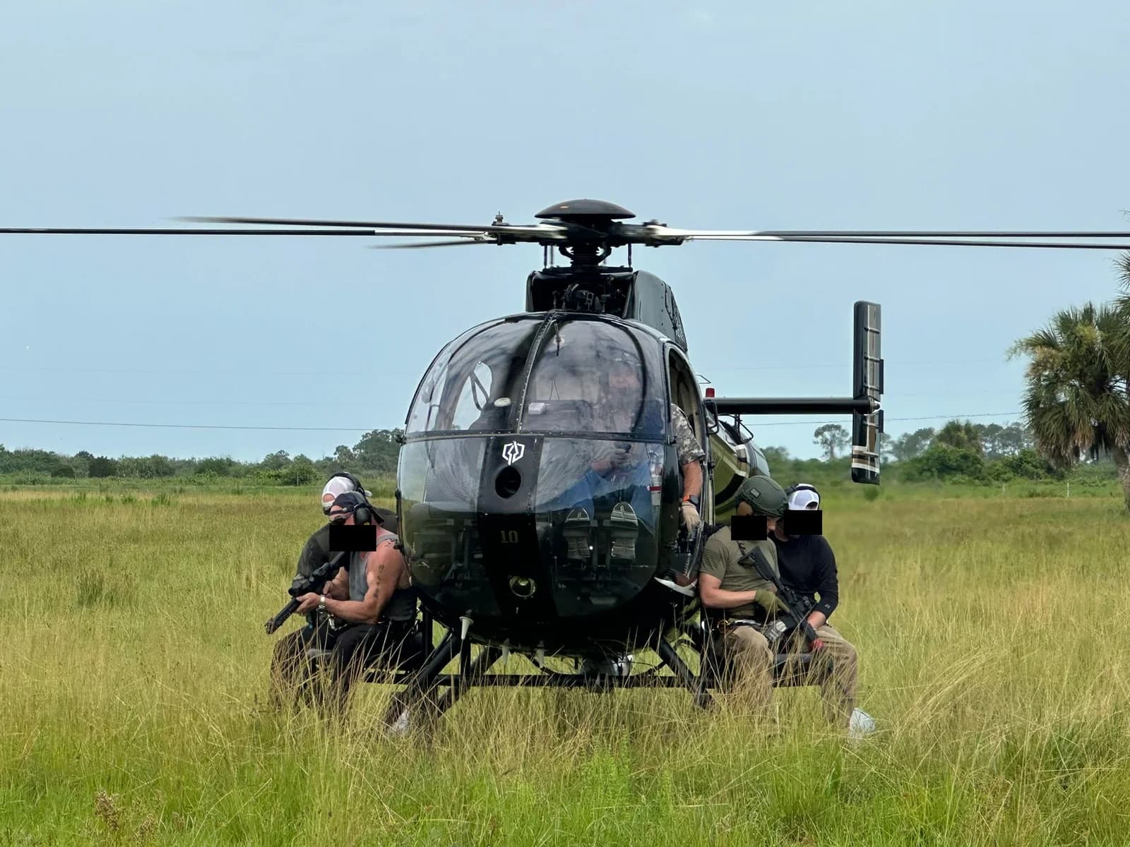 Praetorian academy candidates staged on the skids of a helicopter during an insertion evolution